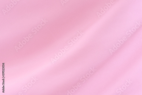 Texture of the synthetic leather is clean and bright pink for background.