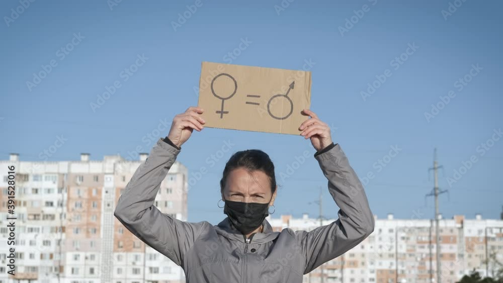 Women's rights. Woman need rights. Woman with a poster of equality between women and men.