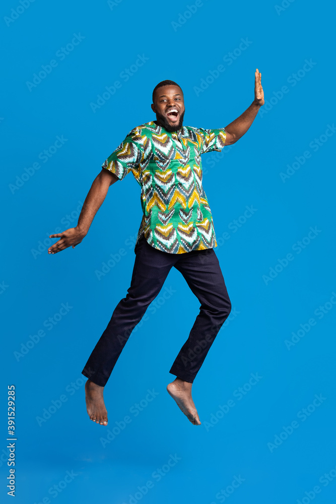 Obraz premium Smiling african american guy having fun, wearing traditional clothes
