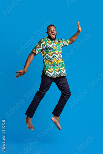 Smiling african american guy having fun, wearing traditional clothes