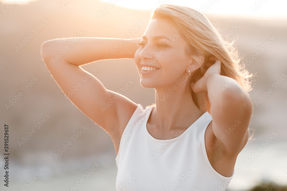 Portrait of a young happy woman outdoor in sunny sunset Portrait of a young happy woman outdoor in sunny sunset