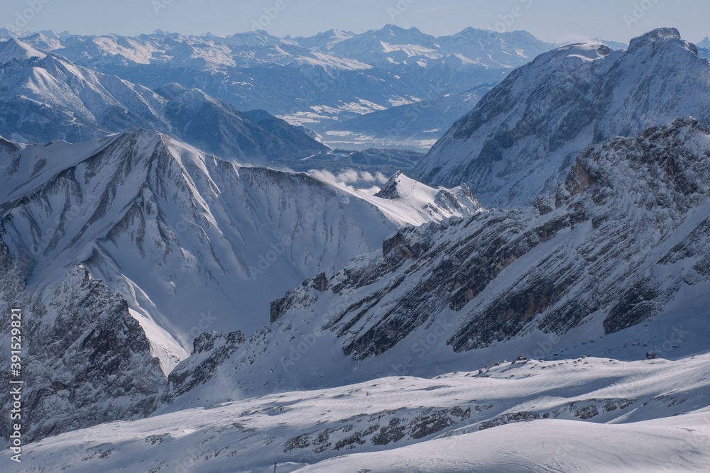 Snow-covered mountains in the Alps in winter, seen from the Zugspitze mountain peak