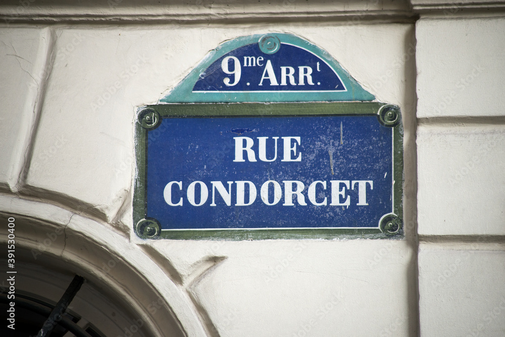 Obraz premium Closeup of Condorcet street name on the traditional parisian street plate on stoned building 