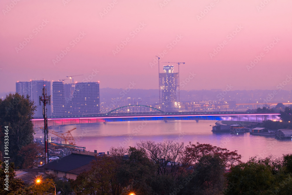 Fototapeta premium Night cityscape and night city lights of Belgrade, Serbia - Kalemegdan fortress and Belgrade waterfront on Sava river