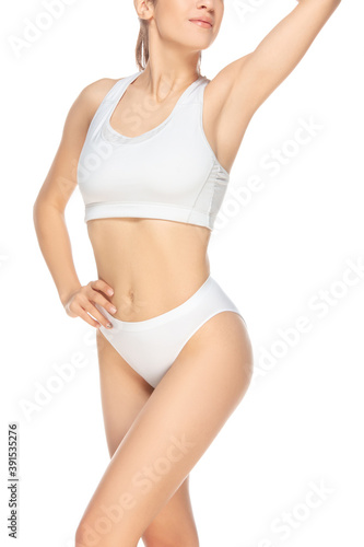 Cropped. Beautiful female model on white background. Beauty, cosmetics, spa, depilation, diet and treatment, fitness concept. Fit and sportive, sensual body with well-kept skin in underwear.
