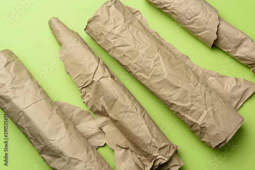 various roll of brown wrapping paper on green background