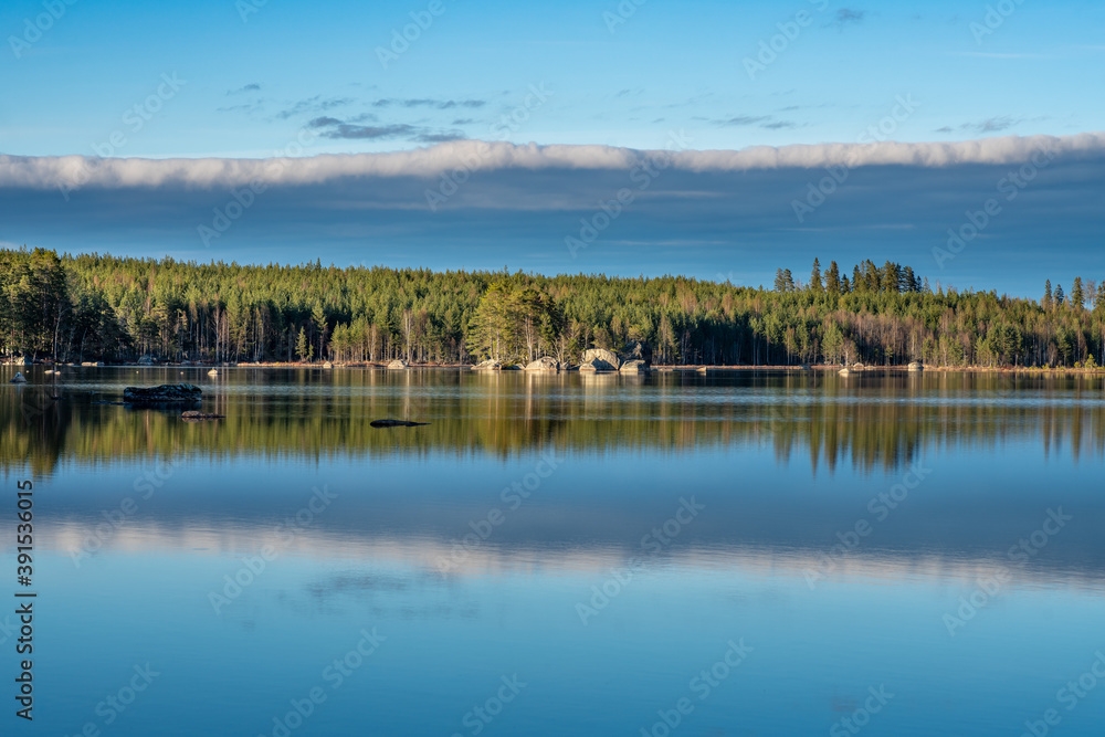 Summer view of the shore of a small lake in Sweden