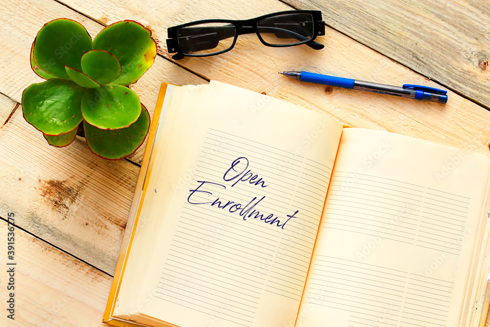 Fototapeta premium OPEN ENROLLMENT text written in a notebook