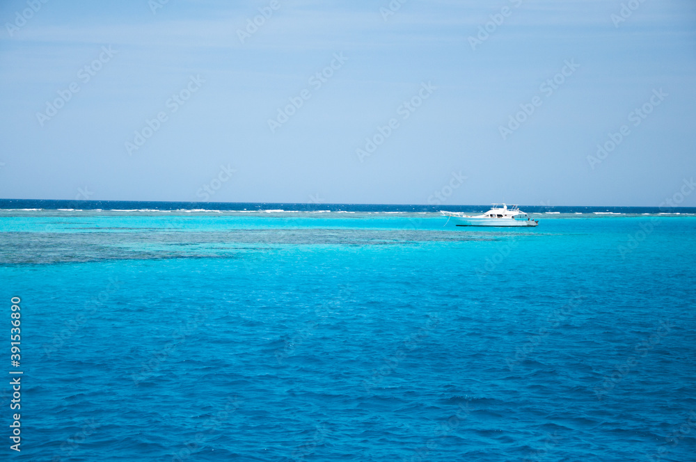 White diving yacht sailing on amazing clear turquoise blue water of Red Sea, Egypt