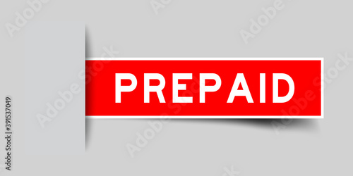 Inserted red color sticker label with word prepaid on gray background