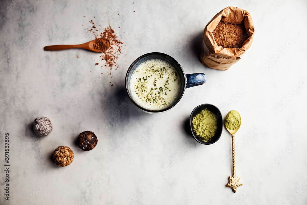 Cup of green matcha latte with chocolates