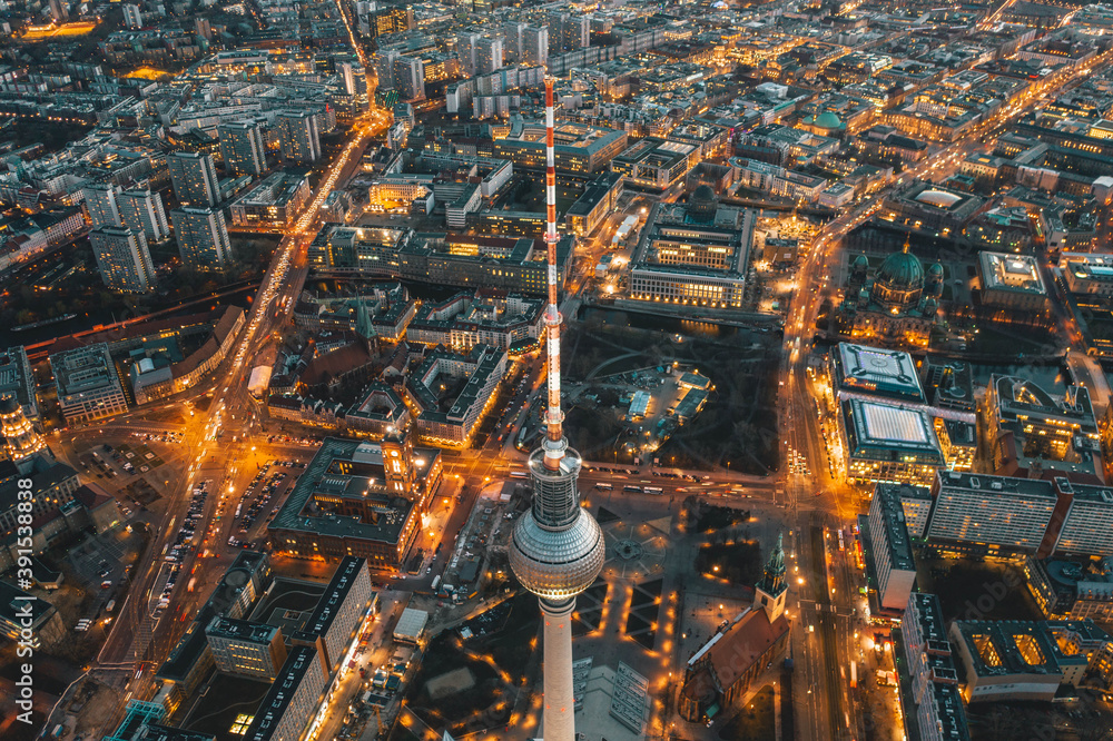 Wide View of Beautiful Berlin, Germany Cityscape after Sunset with lit up Streets and Alexanderplatz TV Tower, Aerial Drone View - obrazy, fototapety, plakaty 