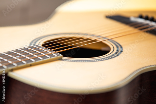 Acoustic guitar strings and sound hole close up 