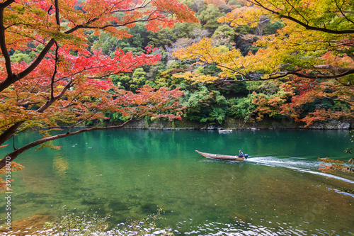 Arashiyama in autumn season along the river. Beautiful place to experience nature in Kyoto, Japan.