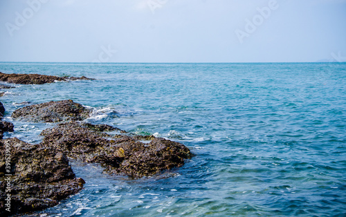 Ocean waves breaking on the rocks on the shore.