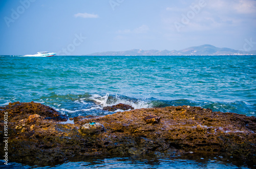 Ocean waves breaking on the rocks on the shore.