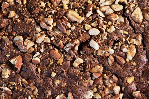 a close up view of a brownie with almonds and nuts photo