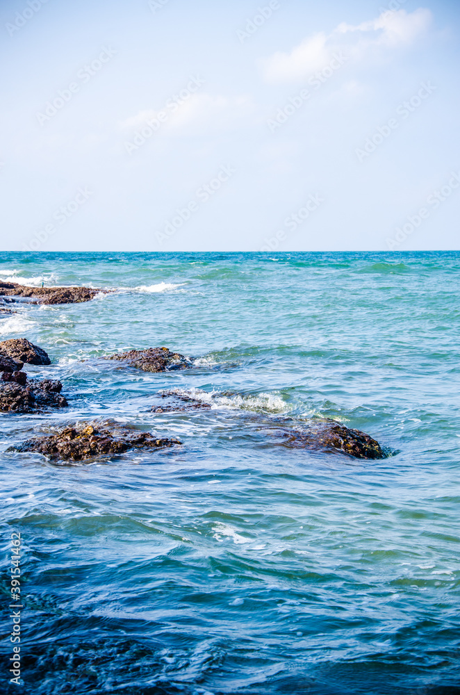 Ocean waves breaking on the rocks on the shore.