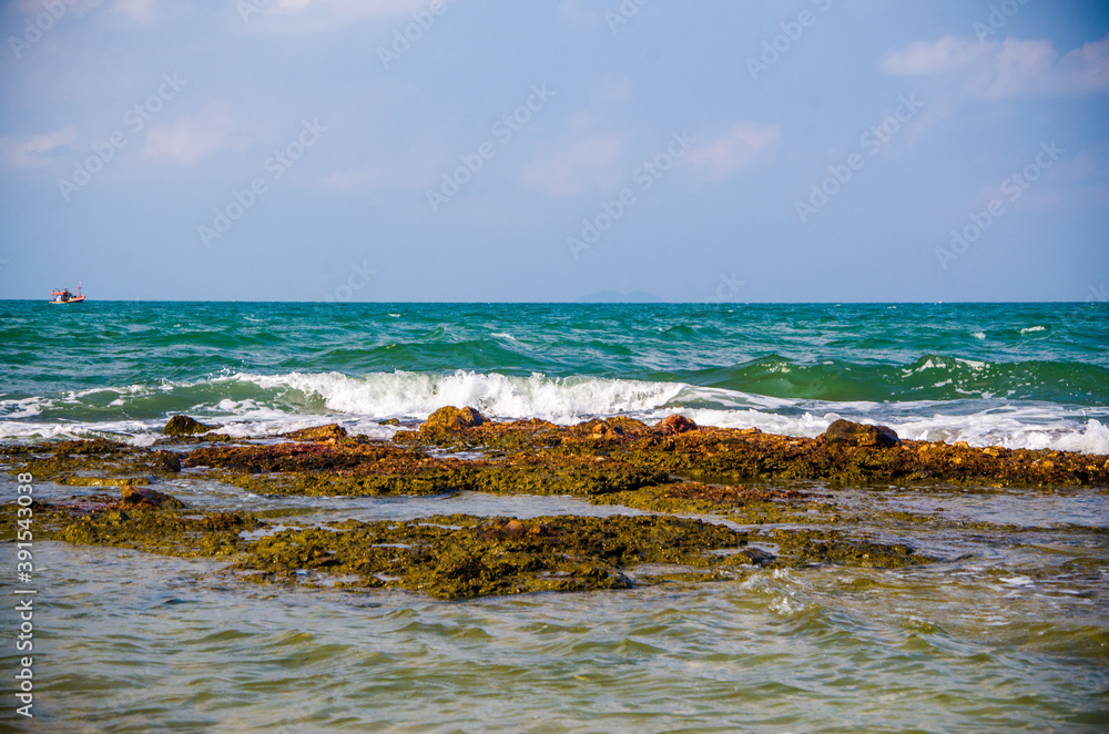Ocean waves breaking on the rocks on the shore.