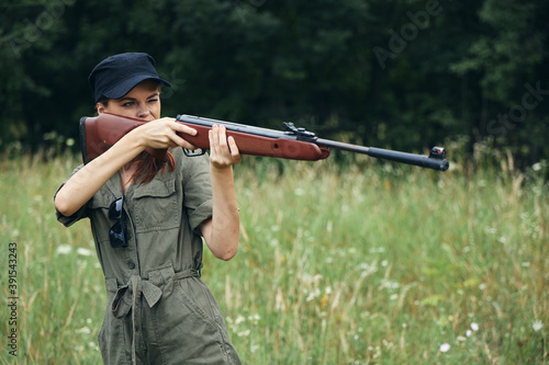 Woman Woman looking into the sight of a gun hunting lifestyle black cap 