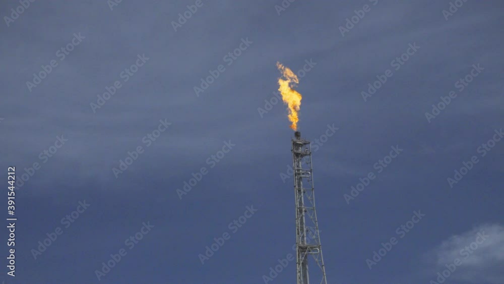 hot burn fire flume on high flare stack of oil refinery in