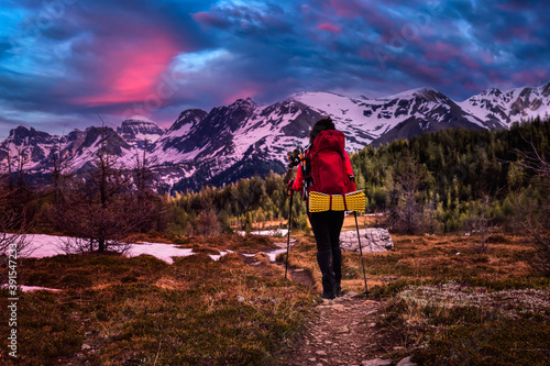 Female Backpacker Hiking in Canadian Rockies. Colorful Twilight Sky Art Render. Taken near Sunshine Village and Banff, Alberta, Canada.
