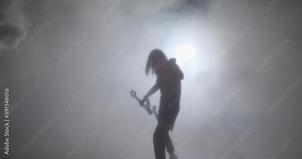 Musician with electric guitar at night in smoke Musician with electric guitar at night in smoke
