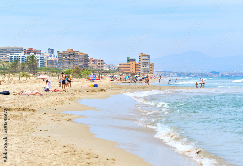 People on the sandy beach of Los Arenales del Sol, Spain