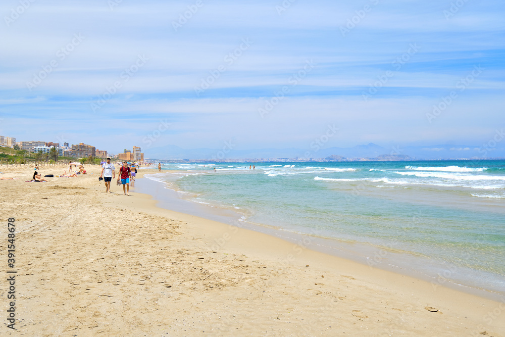 People on the sandy beach of Los Arenales del Sol, Spain