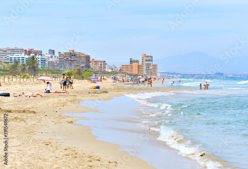 People on the sandy beach of Los Arenales del Sol, Spain