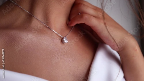 Wedding jewelry on a female neck, the bride fees, morning bride, close up in the hands of the bride jewelry.