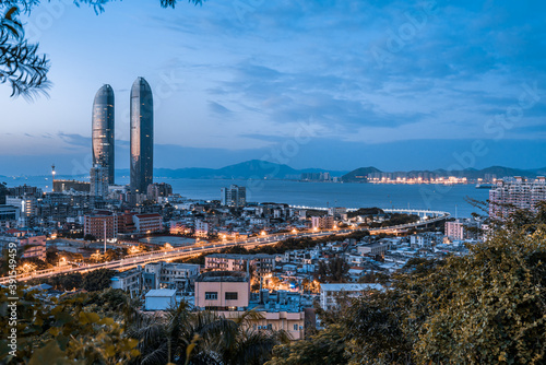 High angle night view of twin towers and Viaduct in Xiamen, Fujian, China