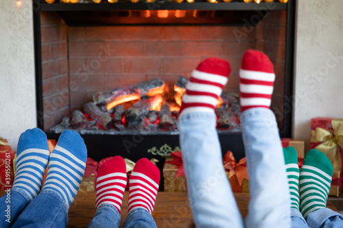 Happy family with children near fireplace at Christmas