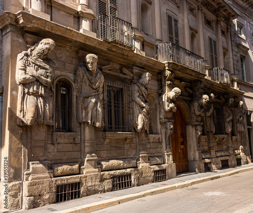 Stone sculptures on a wall in Milan Italy photo