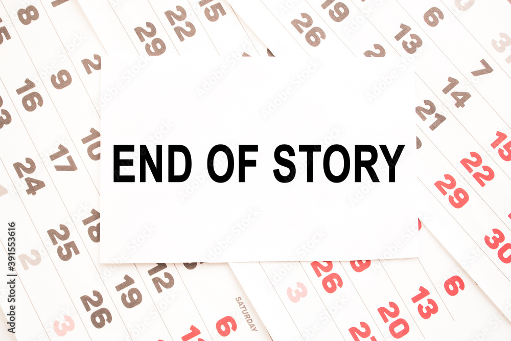 text END OF STORY on a sheet from Notepad.a digital background. business concept . business and Finance.