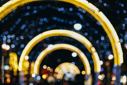 Blurred defocused Christmas city with tree boubles and fairy lights photo