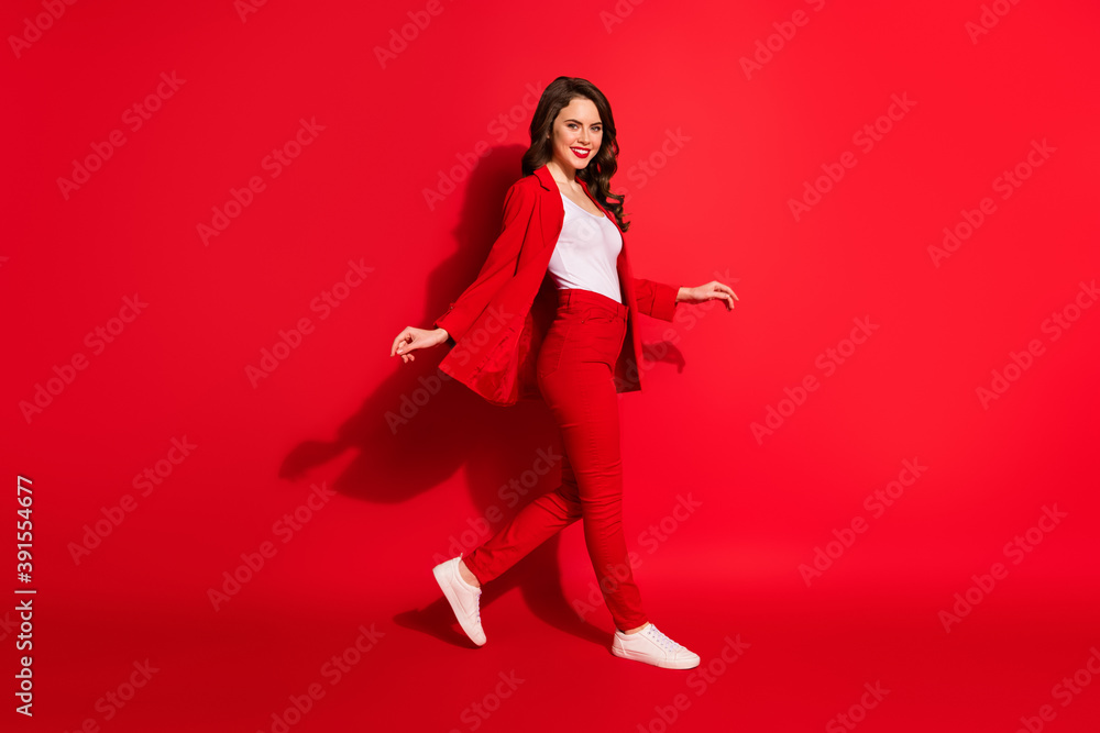 Full body profile side photo of stunning fancy gorgeous girl go empty space isolated over shine red color background Full body profile side photo of stunning fancy gorgeous girl go empty space isolated over shine red color background
