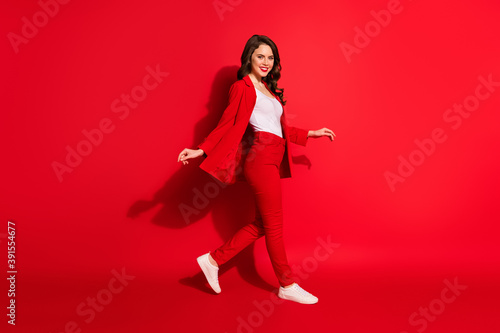 Full body profile side photo of stunning fancy gorgeous girl go empty space isolated over shine red color background