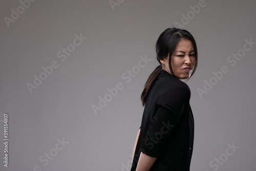 Disdainful woman showing her disgust or dislike photo