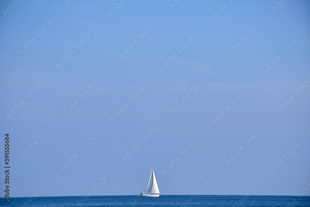 White sailboat on the Mediterranean Sea, seen from Larnaca, Cyprus