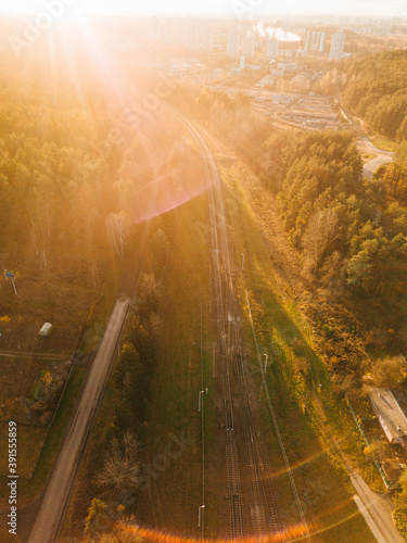 Train moving on trailorad through forest on sunset. beautiful landscape from above. aerial shot on drone