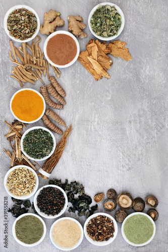 Adaptogen healthy food with herb, spices & supplement powders. Plant based foods that help the body deal with stress & promote or restore normal physiological functions. Top view on grunge background