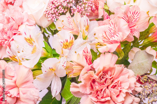 Bouquet of soft pink flowers in wrapping paper.