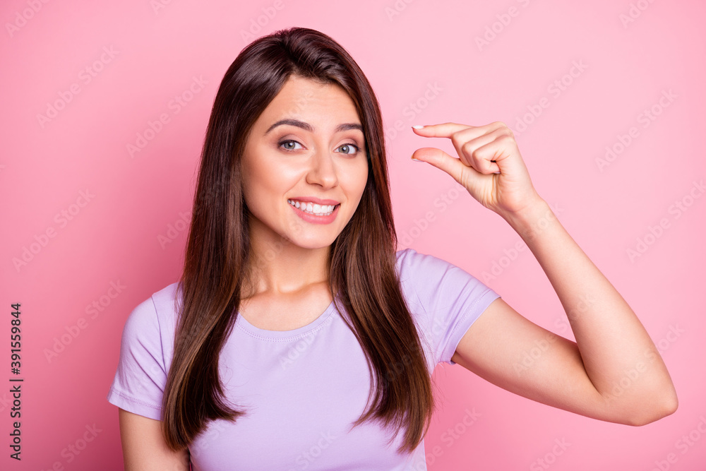 Portrait of cute young girl show measure gesture dressed casual wear isolated on pink color background Portrait of cute young girl show measure gesture dressed casual wear isolated on pink color background