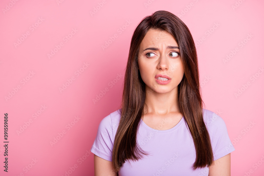 Portrait of emotional young woman girl feel disgust look empty space dressed violet t-shirt isolated on pink color background Portrait of emotional young woman girl feel disgust look empty space dressed violet t-shirt isolated on pink color background