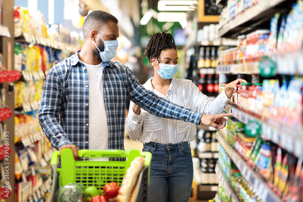 African Husband And Wife In Masks Shopping Groceries In Supermarket