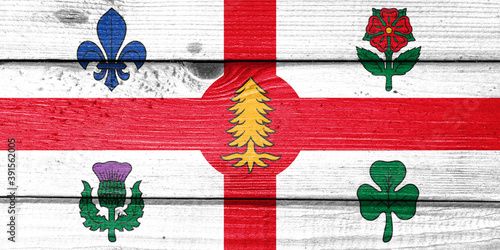montreal flag painted on old wood plank background. Brushed natural light knotted wooden board texture. Wooden texture background flag of montreal