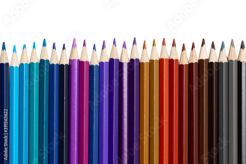 Many colorful pencils in a row isolated on white background.