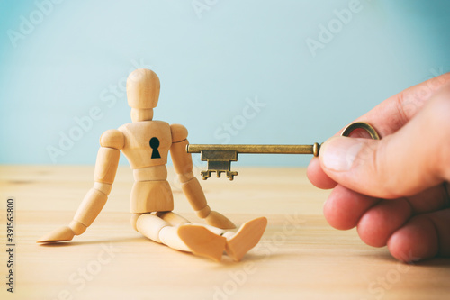 concept of unlock your potential. person hand with key to dicover new talents and achievements photo