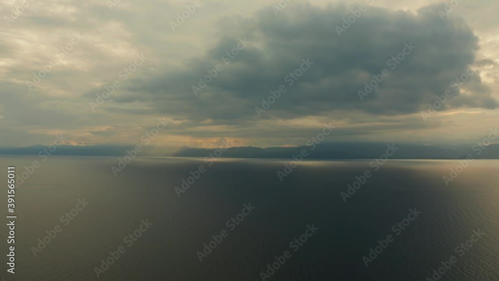 Sunset above the sea surface with waves, top view. Reflected sun on a water surface. Sunset over ocean. Seascape, Summer and travel vacation concept Sunset above the sea surface with waves, top view. Reflected sun on a water surface. Sunset over ocean. Seascape, Summer and travel vacation concept